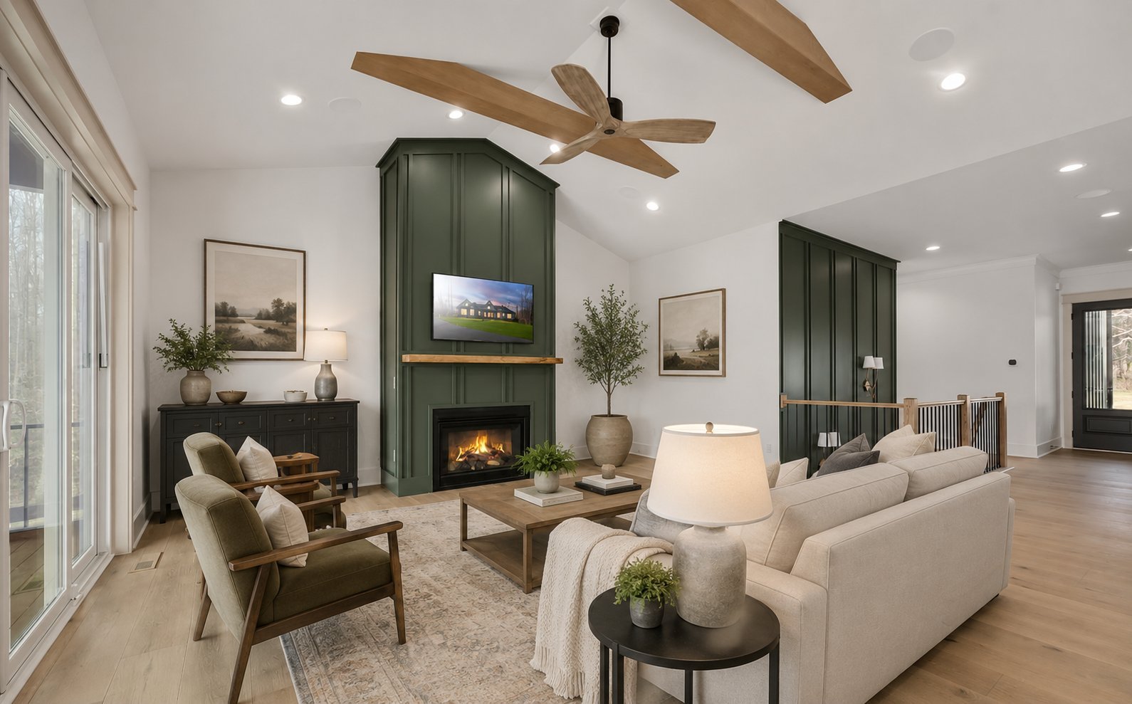 Modern living room with green fireplace, cream sofa, wood ceiling fan, and hardwood floors